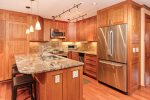 Beautiful kitchen with stainless steel appliances and stone countertops
